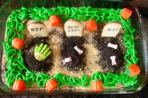 Spooky Graveyard Brownies are a fun food craft to do with the kids this Halloween. Cookies become tombstones and cookie crumbs, spooky sprinkles and edible zombie hands act as decorations.