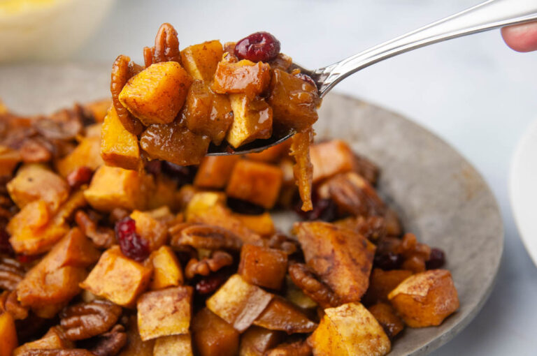 A spoon of butternut squash over a platter