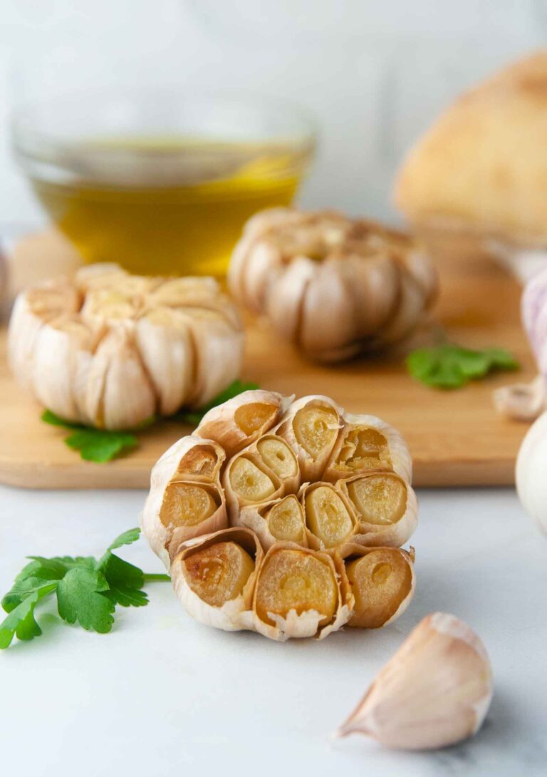 Roasted Garlic on a cutting board in a white kitchen