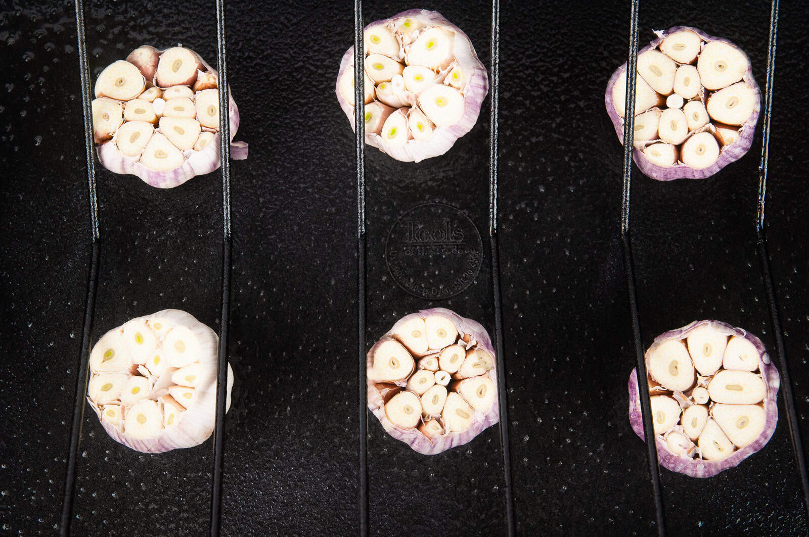 Put cut heads of garlic in the roasting pan underneath where the turkey will lay