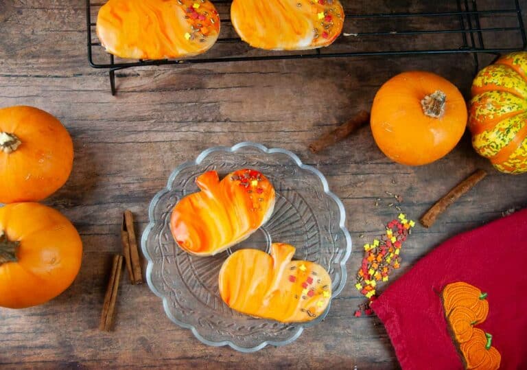 Marbled icing and sprinkles is an easy way to decorate pumpkin spice cut out cookies.