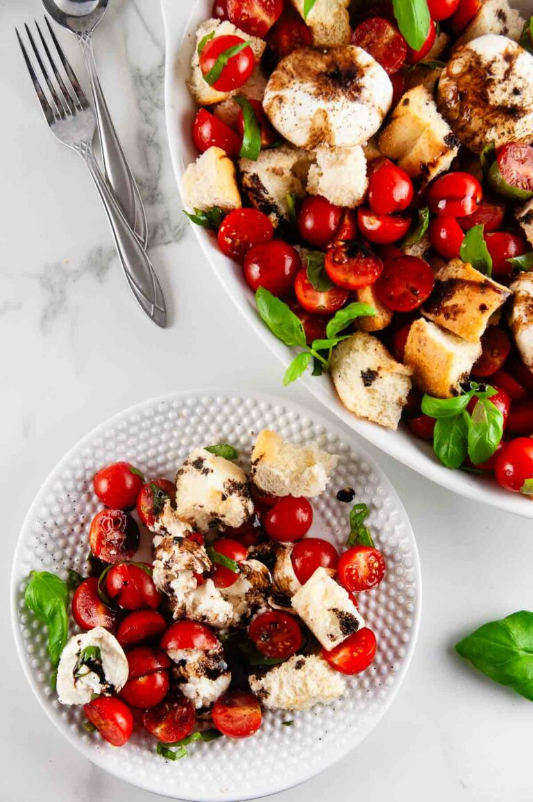 Burrata panzanella salad is the best kind of salad! This rustic salad is one made solely of creamy burrata, toasted pieces of Italian bread, bright tomatoes, and slathered in tangy, sweet balsamic.