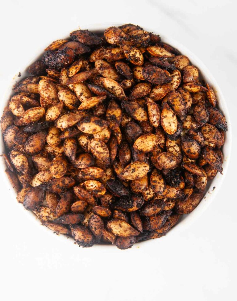 This easy roasted butternut squash seeds recipe creates a savory crunchy snack or topping for fall and winter salads and soups. You'll never throw the seeds away again after you taste these!