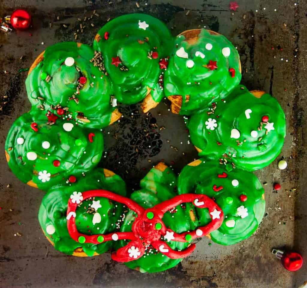 Learn how to make the cutest easy cinnamon roll wreath to serve for Christmas morning breakfast or any holiday occasion. This short cut recipe lets you put something festive and magical on the table without fussing over homemade cinnamon buns or stressing over another big meal.