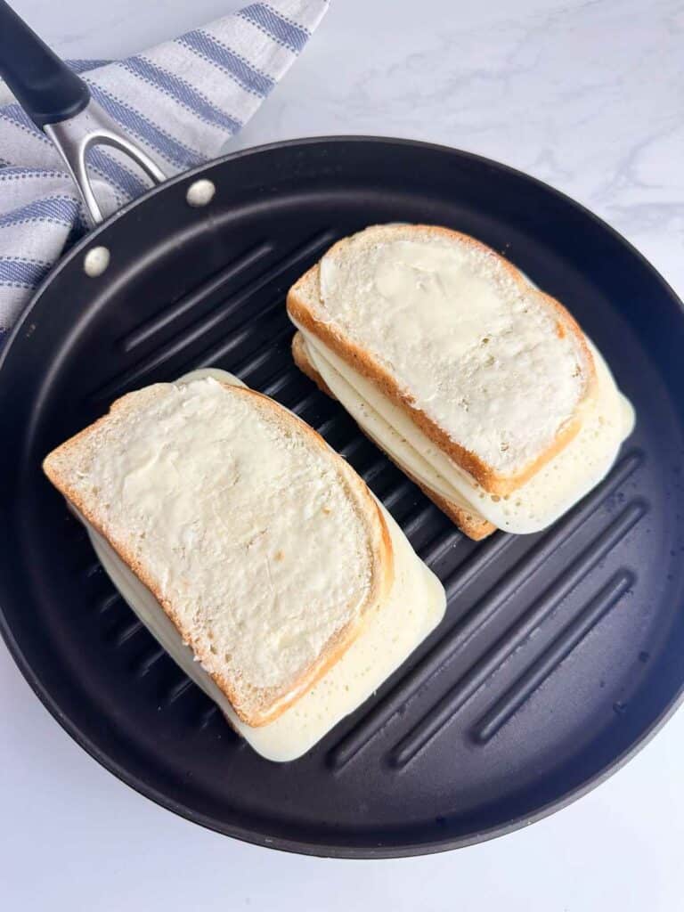 Close the panini with another slice of bread that has the mayo mixture on the inside and is buttered on the outside.