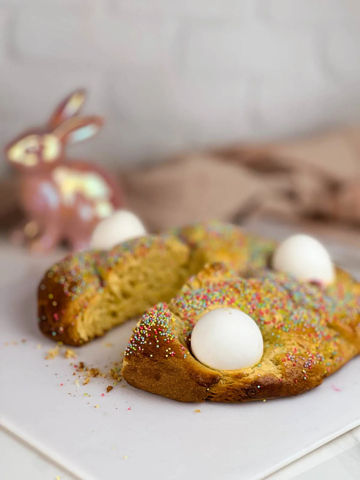 Italian Easter bread is a traditional slightly sweet brioche style perfect for the springtime holiday. This fluffy, braided bread dotted with eggs and sprinkles is a festive addition to your Easter brunch.