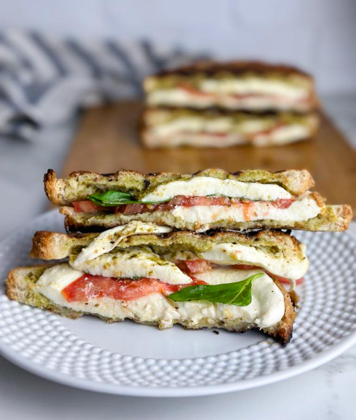 This caprese panini sandwich with pesto features ooey, gooey mozzarella cheese, sweet tomato slices, fragrant basil, and bright herby pesto pressed between two slices of golden brown bread. The perfect easy lunch or dinner!