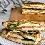 This caprese panini sandwich with pesto features ooey, gooey mozzarella cheese, sweet tomato slices, fragrant basil, and bright herby pesto pressed between two slices of golden brown bread. The perfect easy lunch or dinner!
