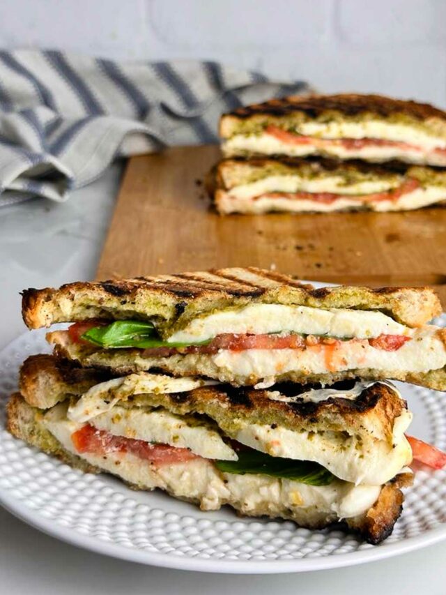 This caprese panini sandwich with pesto features ooey, gooey mozzarella cheese, sweet tomato slices, fragrant basil, and bright herby pesto pressed between two slices of golden brown bread. The perfect easy lunch or dinner!