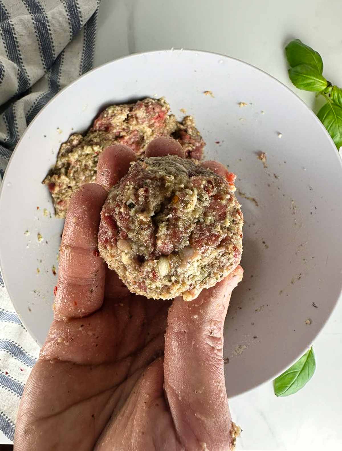 Roll the meat mixture into equal sized round meatballs.