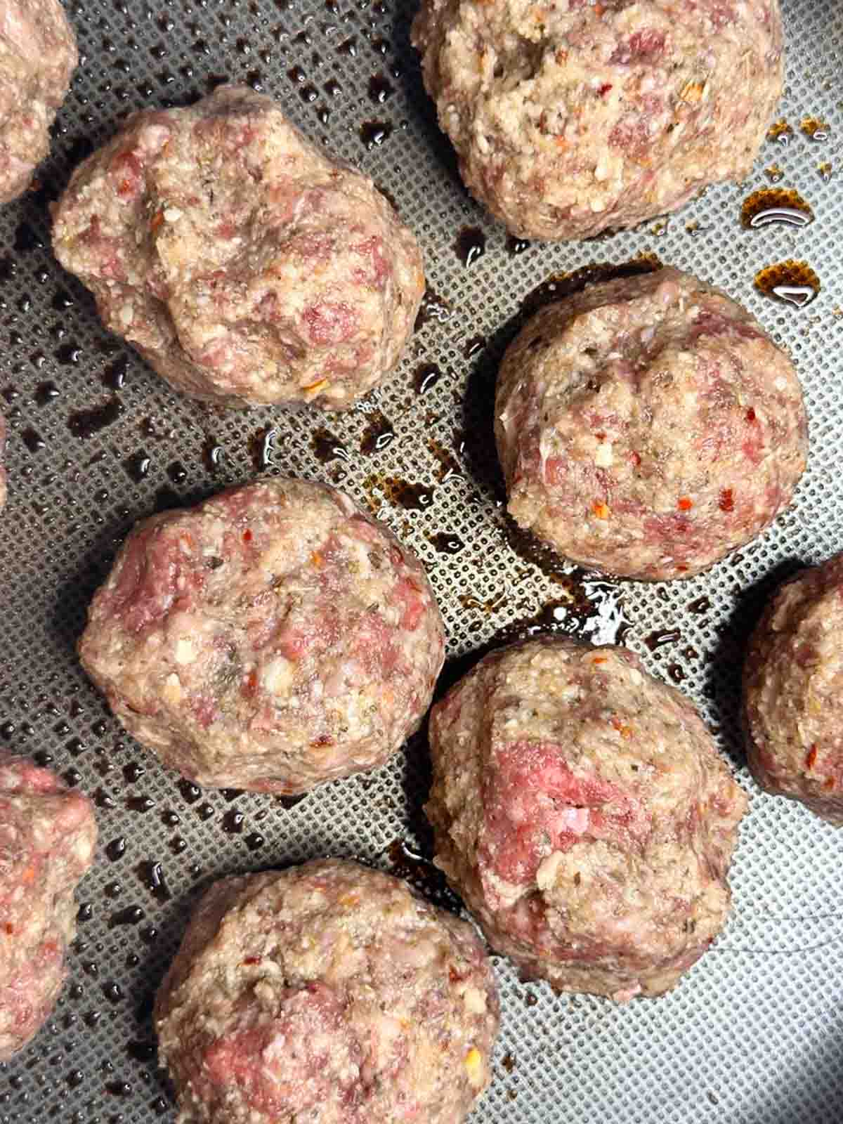 Sear the meatballs in a large pan with olive oil.