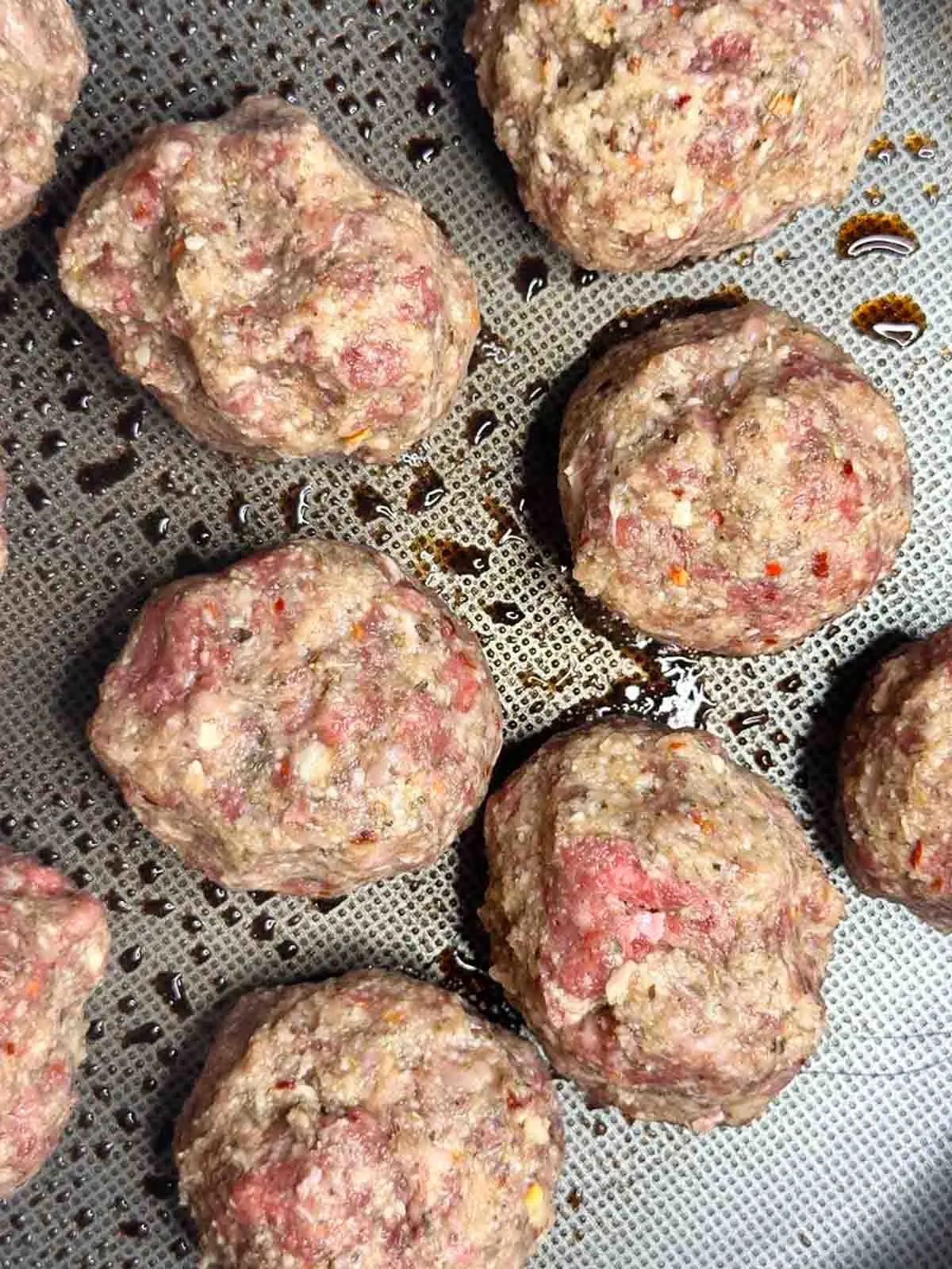 Sear the meatballs in a large pan with olive oil.