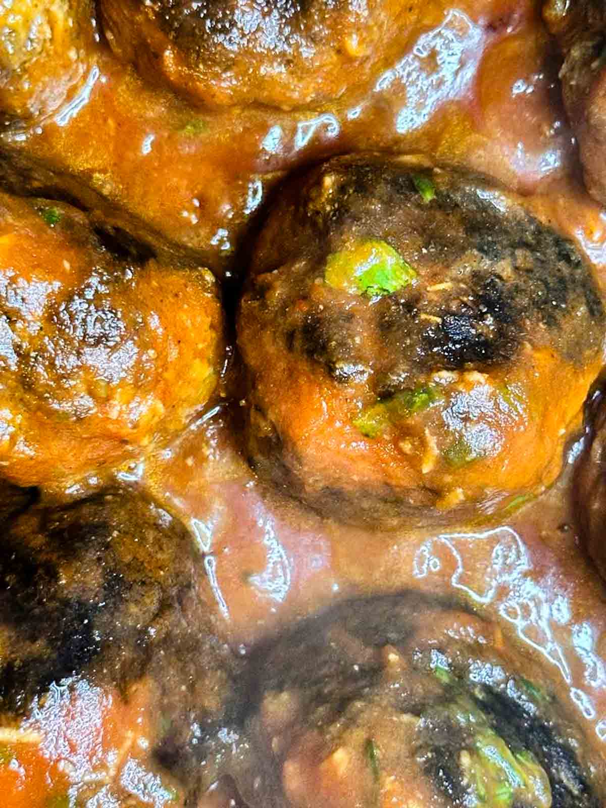 Finish cooking the meatballs in tomato sauce until they are cooked through.