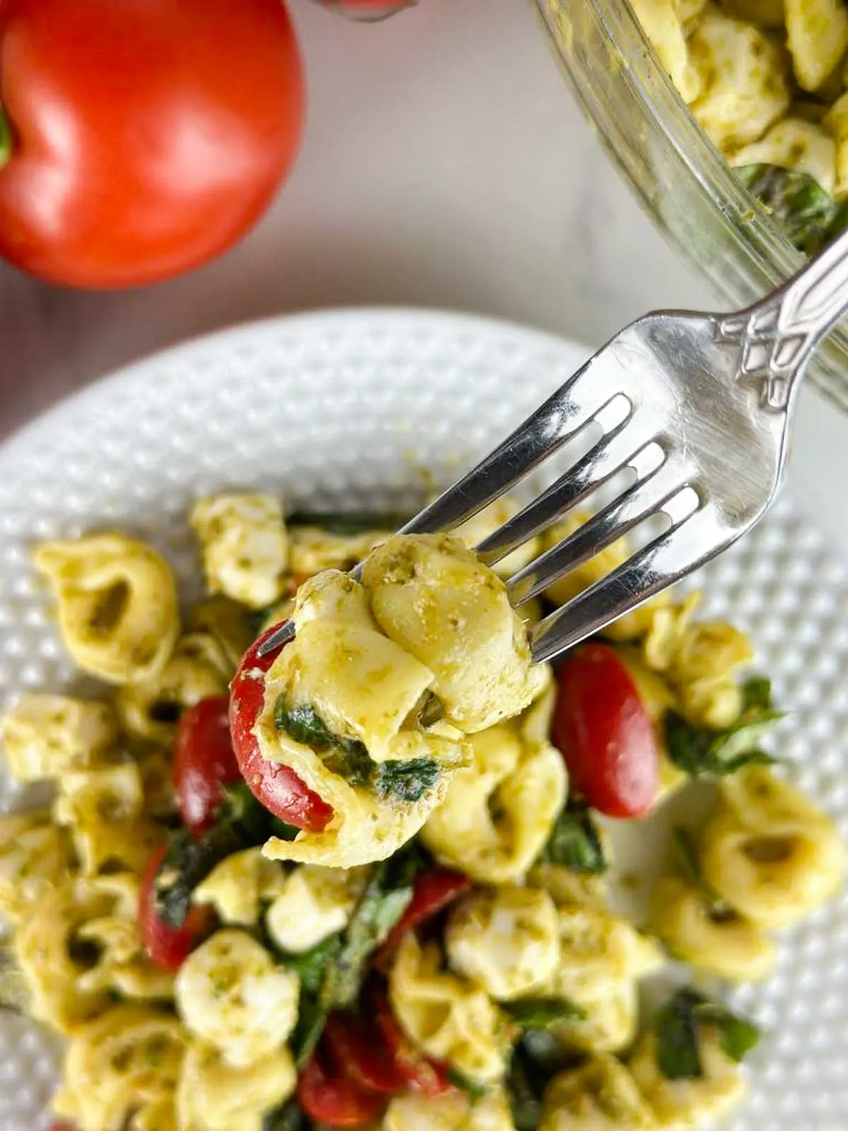 Caprese tortellini pasta salad with pesto is a fresh take on pesto pasta salad. Pillowy cheese tortellini gets tossed with lemon pesto, sweet cherry tomatoes, fragrant basil, and creamy mozzarella for a delicious cold pasta dish you'll love!