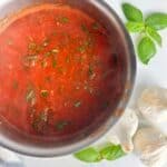 A pot of real Italian tomato sauce with basil ready to be spooned over spaghetti, meatballs, or anything else you can think of!