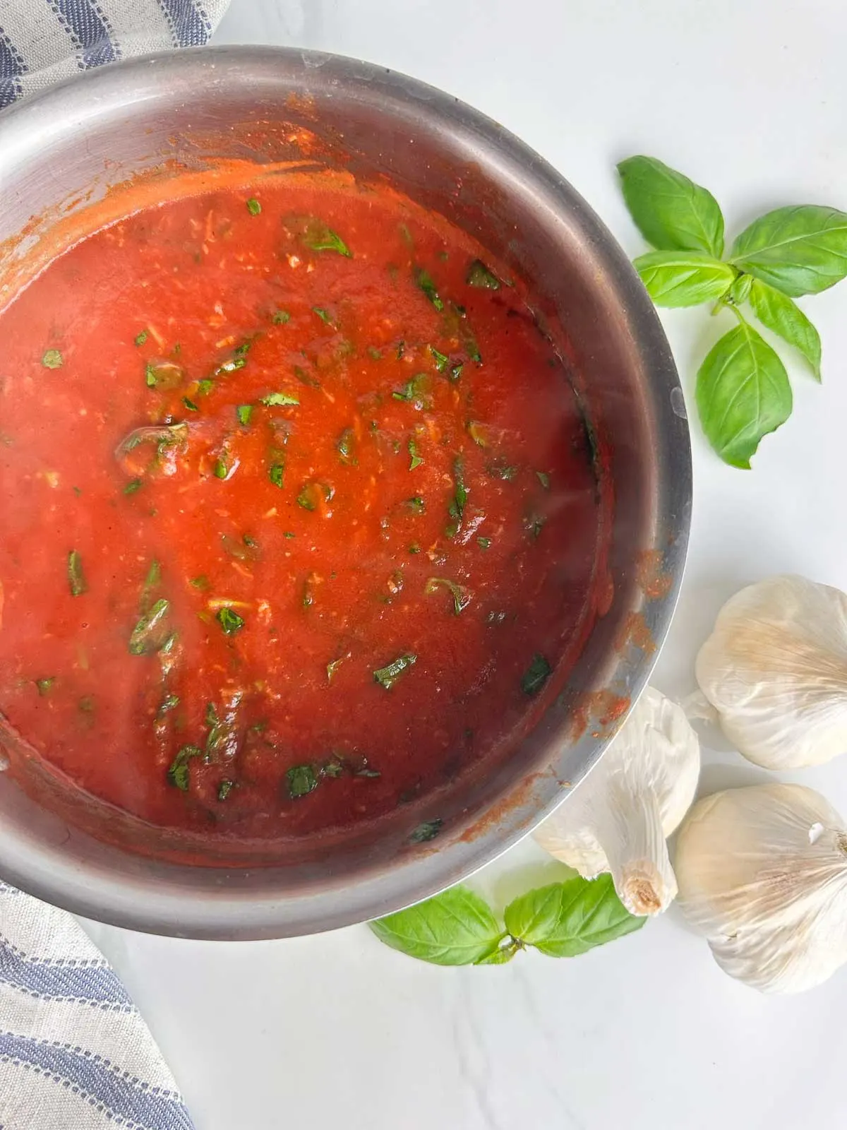 A pot of real Italian tomato sauce with basil ready to be spooned over spaghetti, meatballs, or anything else you can think of!