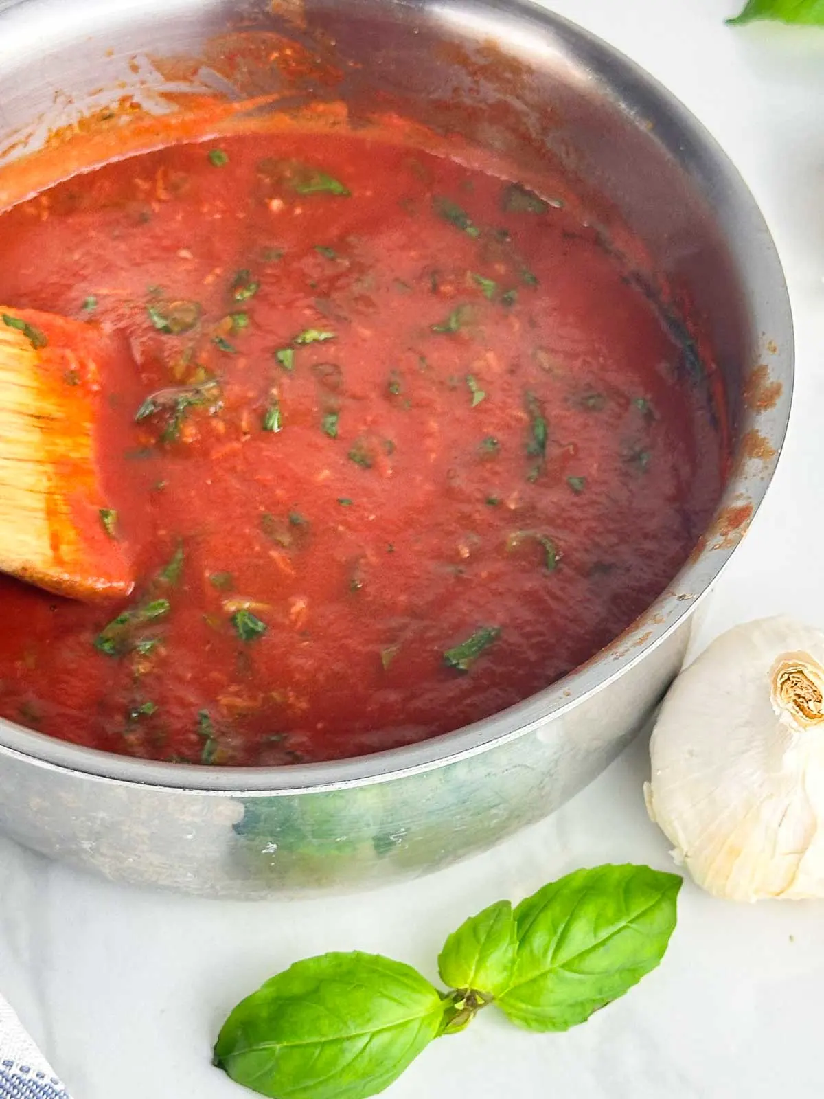 A pot of real Italian tomato sauce with basil ready to be spooned over spaghetti, meatballs, or anything else you can think of!
