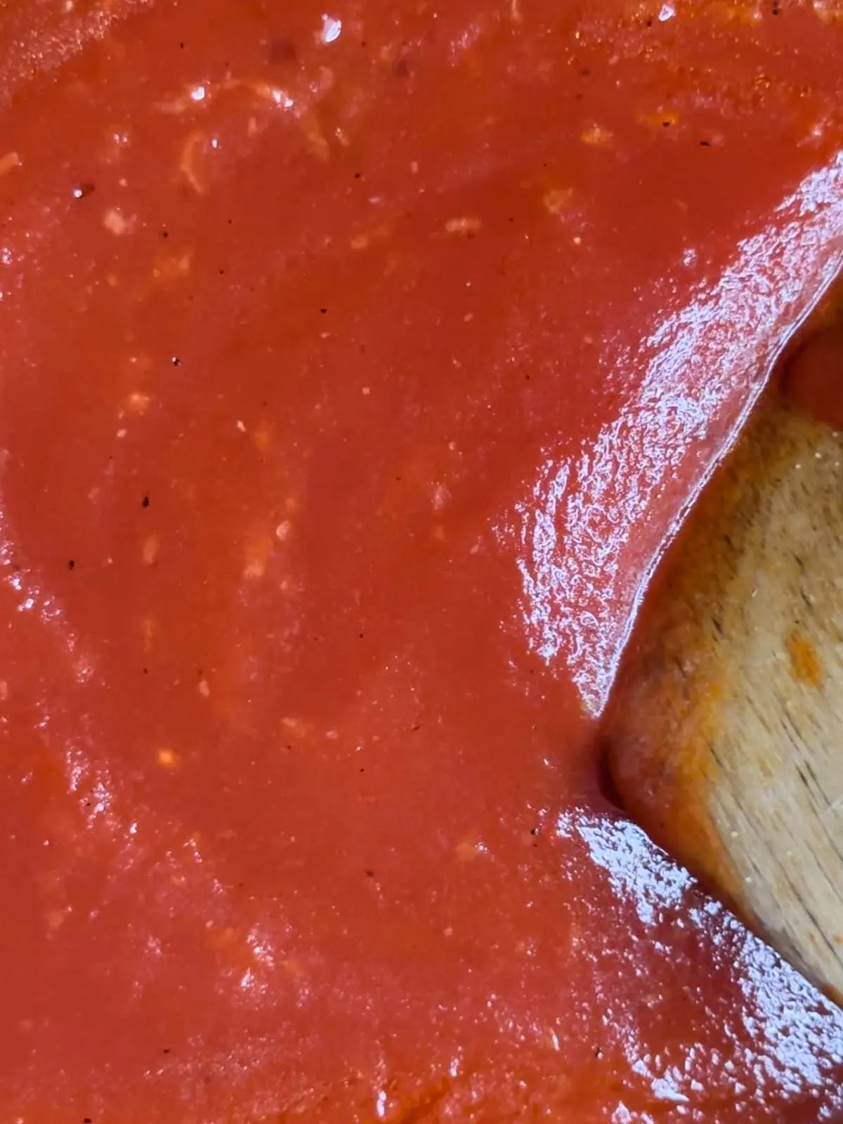 Stir the crushed tomatoes into the garlic olive oil mixture and bring this to a simmer.