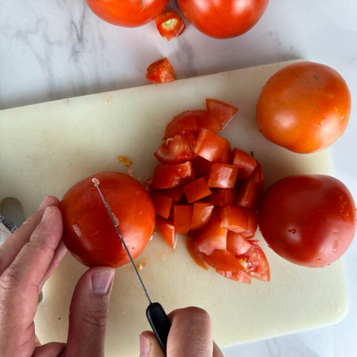 Cut the tomatoes into bite sized pieces.