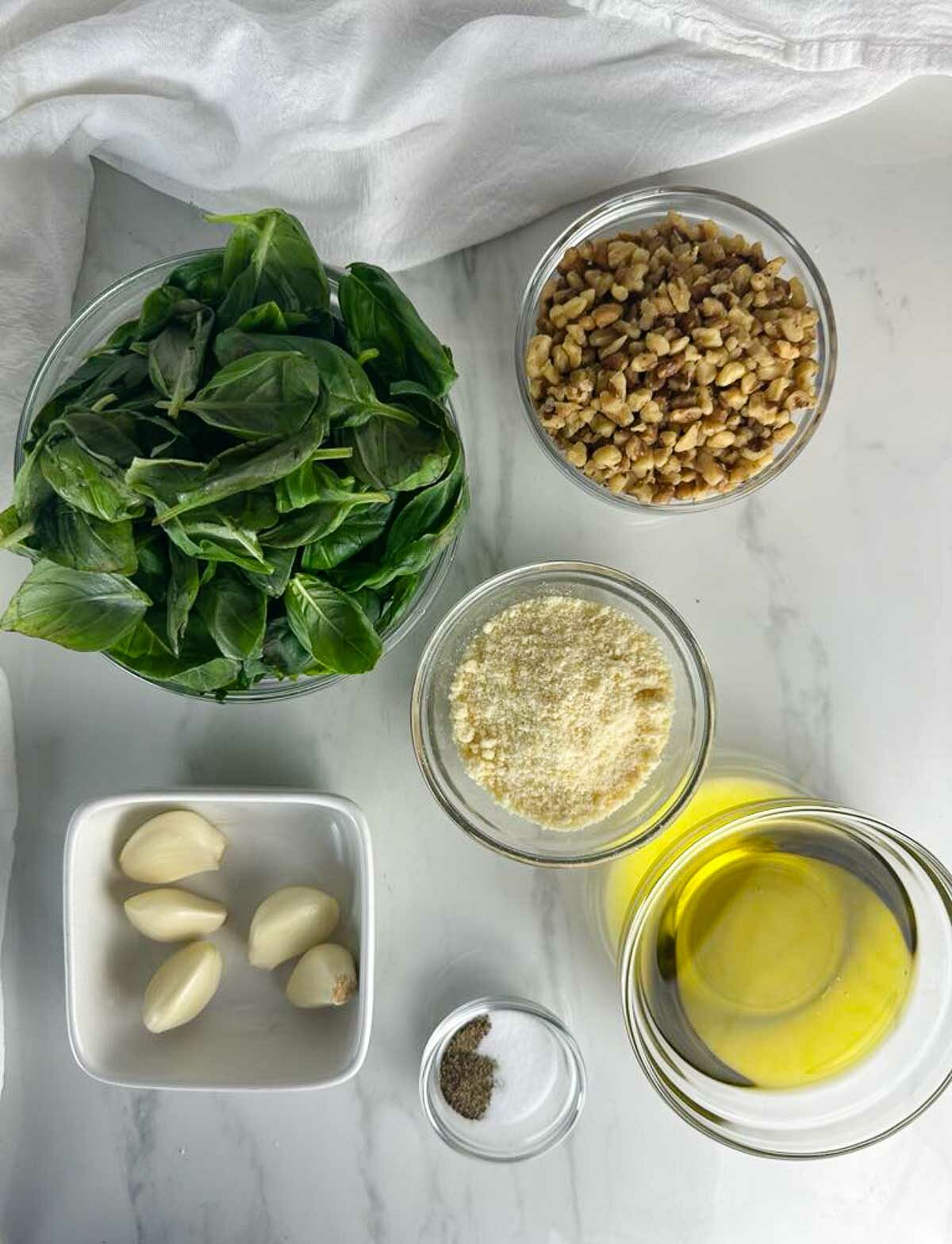 Ingredients for Basil Pesto Sauce with Walnuts: Basil, Walnuts, Garlic, Parmesan Cheese, Salt, Pepper, and Olive Oil