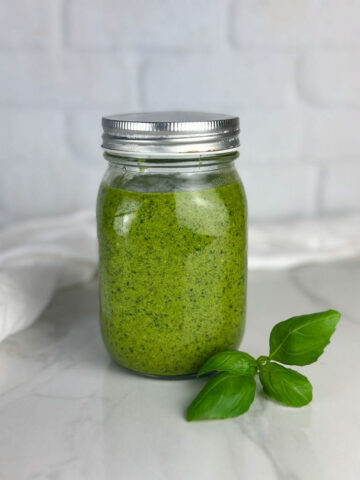 Our basil pesto sauce with walnuts skips the pine nuts altogether for an easy alternative of this classic sauce. Homemade basil walnut pesto makes a delicious addition to pasta, gnocchi, salads, and meats. Make it and never go back to store bought!