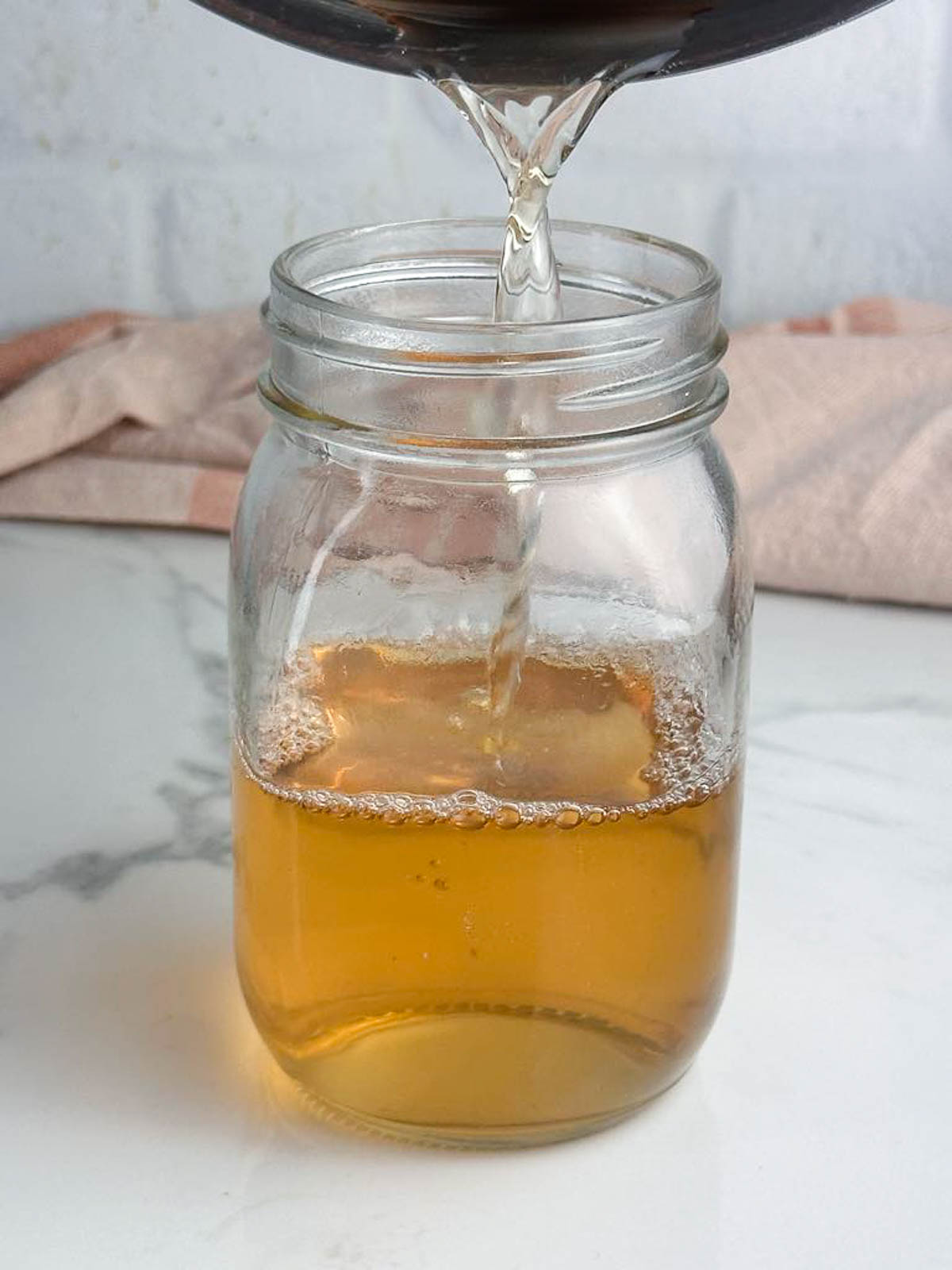Pour the vanilla simple syrup into a jar for easy storage.