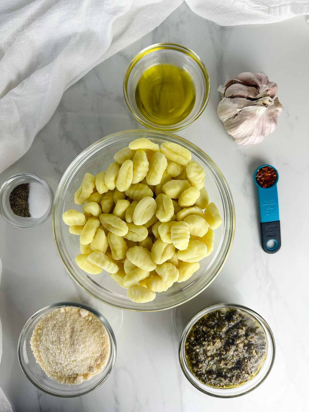 Ingredients for Gnocchi with Pesto Sauce: Gnocchi, Olive Oil, Salt, Pepper, Red Pepper, and Pesto