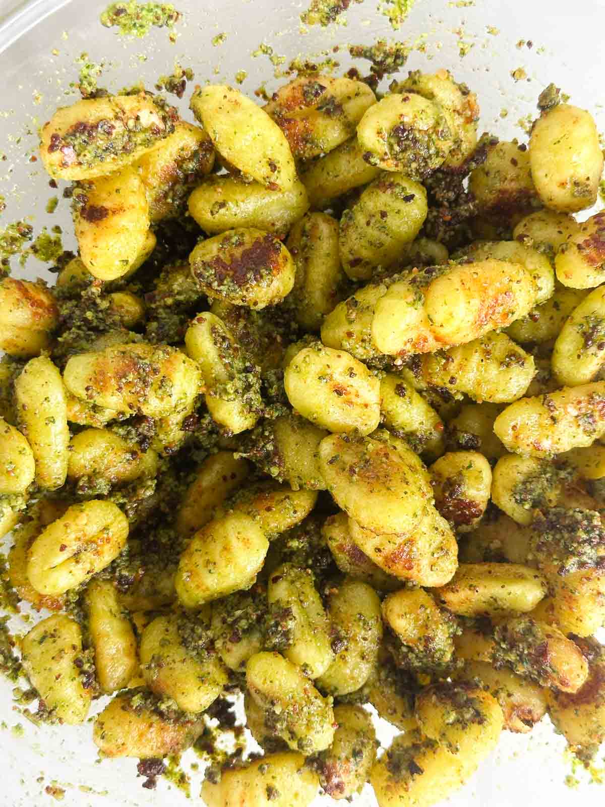 Toss the baked gnocchi with pesto sauce