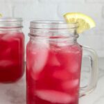 A photo of 2 mason jar mugs of blueberry lemonade set into a text box reading blueberry lemonade