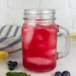 A photo of 2 mason jar mugs of blueberry lemonade set into a text box reading blueberry lemonade