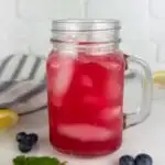 A photo of 2 mason jar mugs of blueberry lemonade set into a text box reading blueberry lemonade