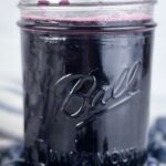 A photo of a jar of blueberry simple syrup set into a text box reading blueberry simple syrup