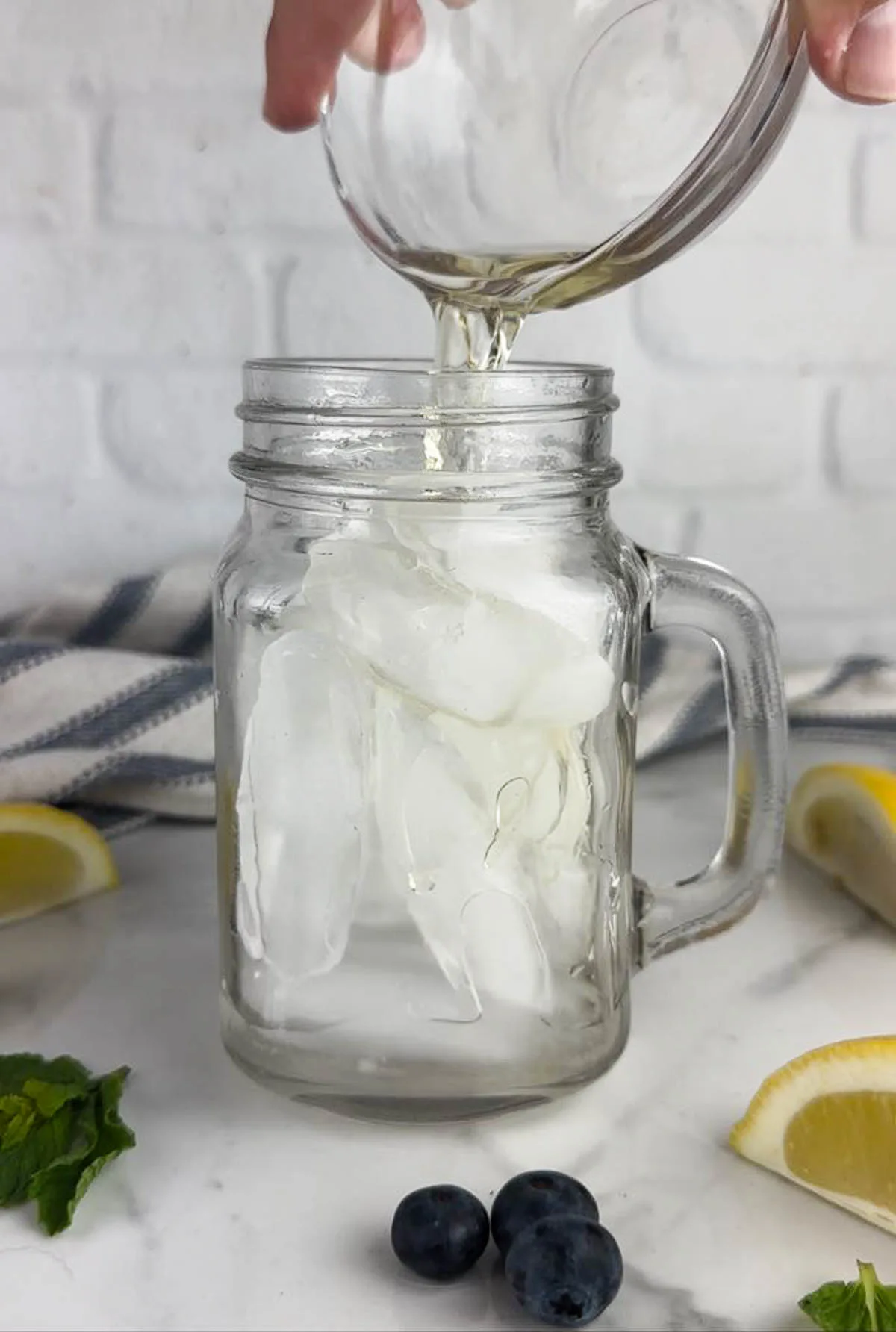 Add the limoncello and vodka to a glass with ice.