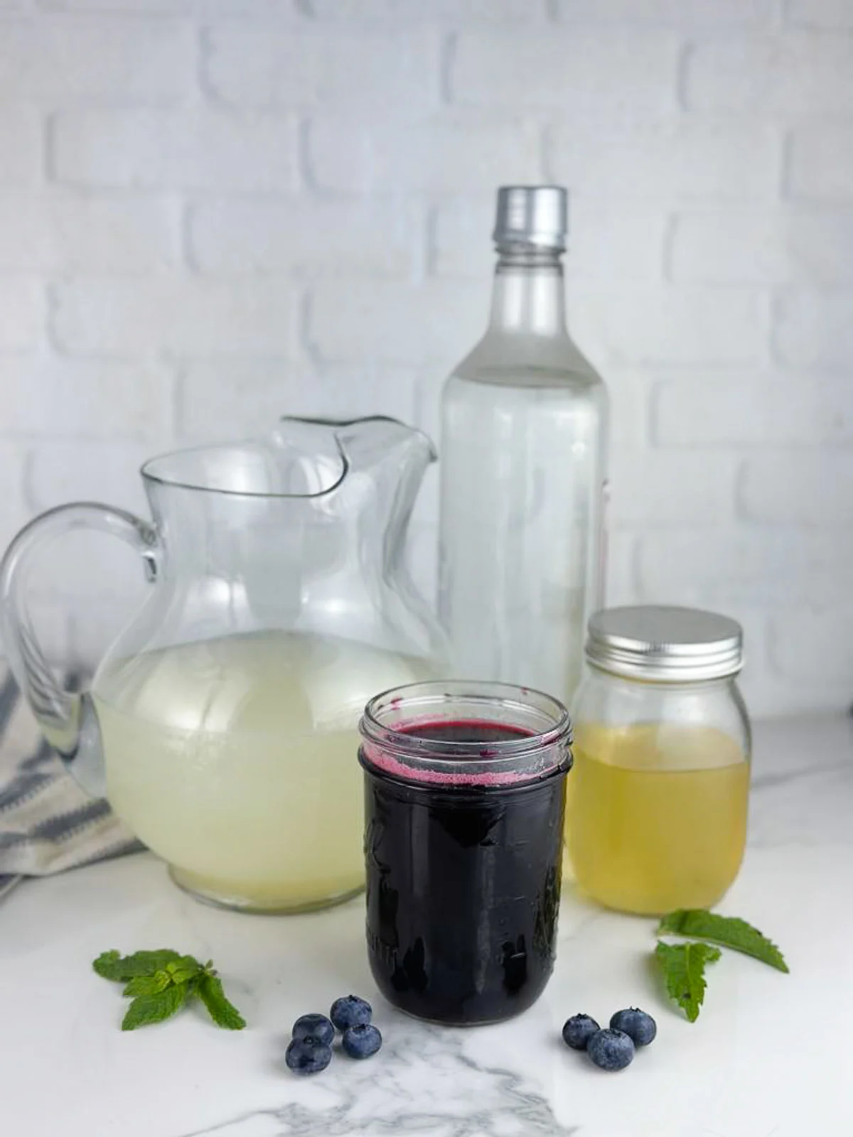 Ingredients for Easy Blueberry Vodka Lemonade Cocktails: Lemonade, Blueberry Simple Syrup, Vodka, and Limoncello