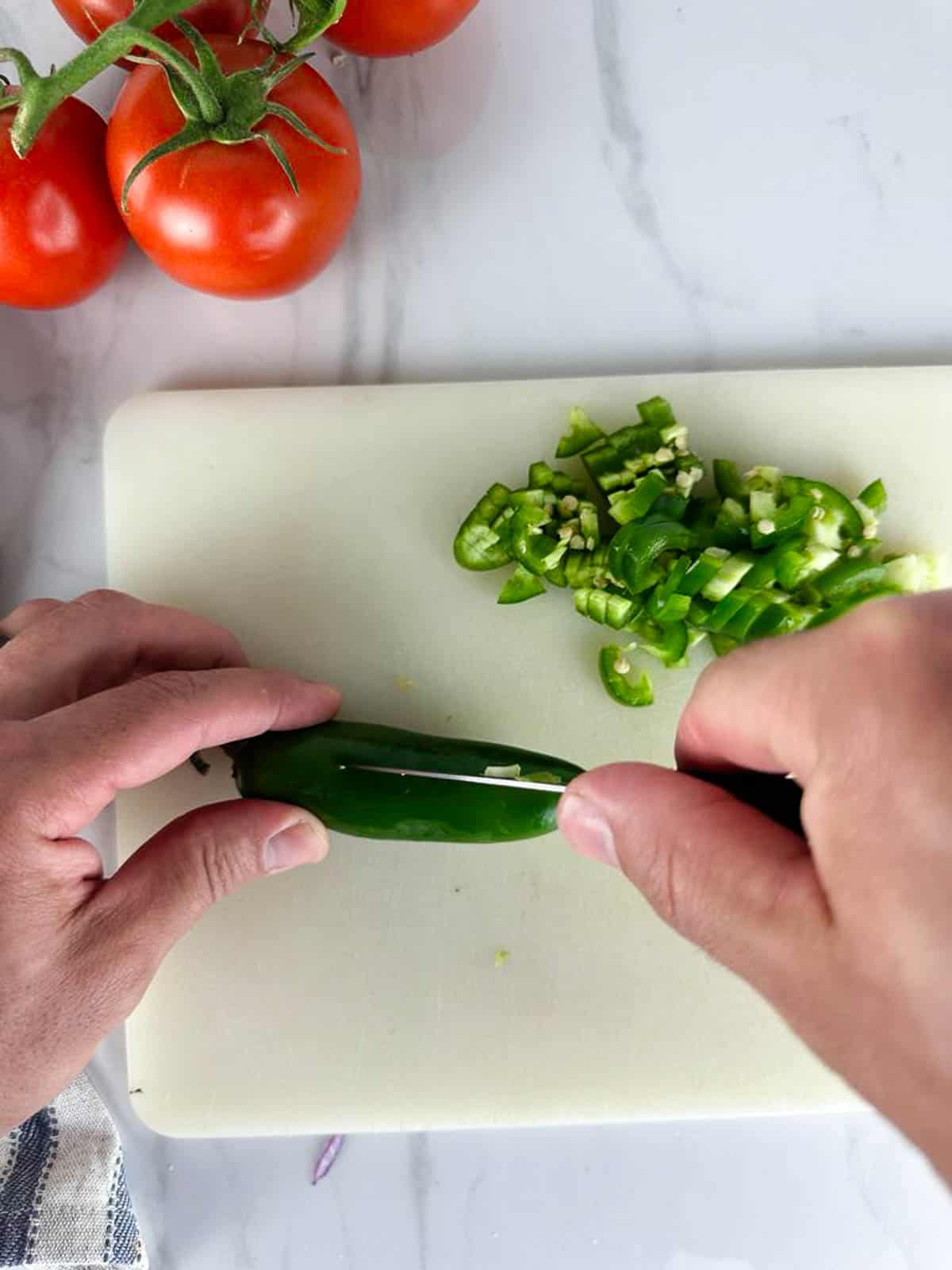 Dice the jalapenos for this fresh tomato salsa recipe.