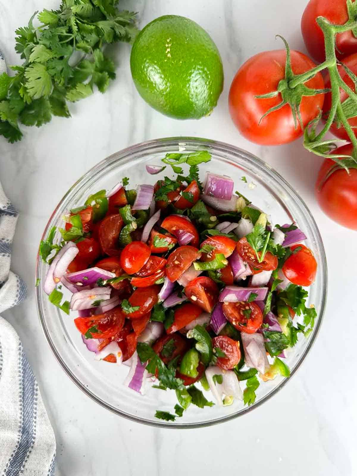 Toss the fresh tomato salsa with fresh lime juice and season with salt and pepper to taste.