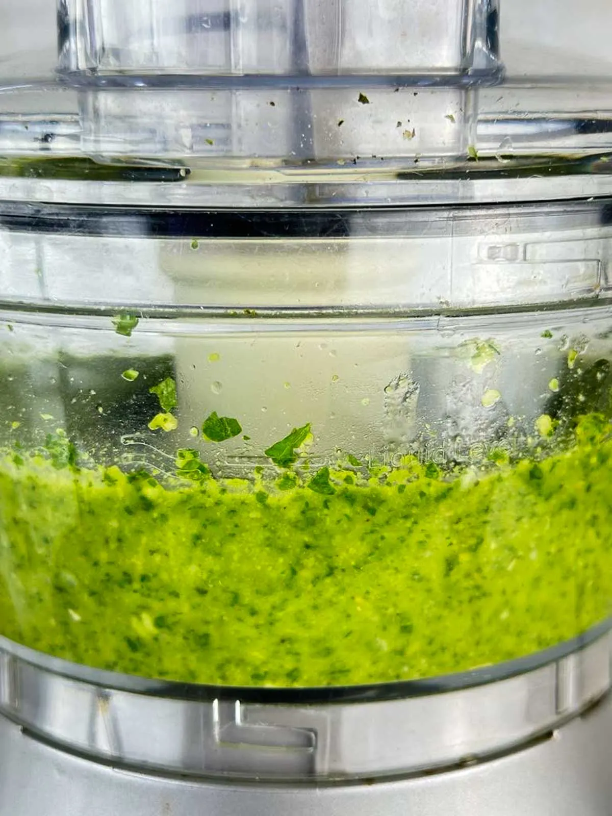 Stream the olive oil into the pesto Genovese