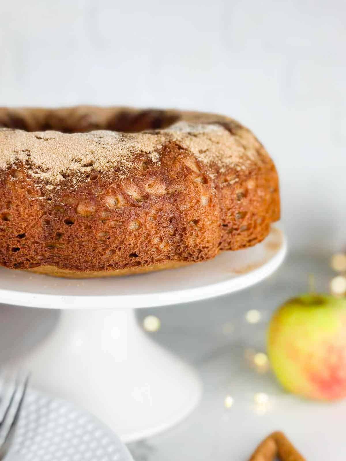 Apple Cider Donut dusted with cinnamon sugar cake on a cake stand