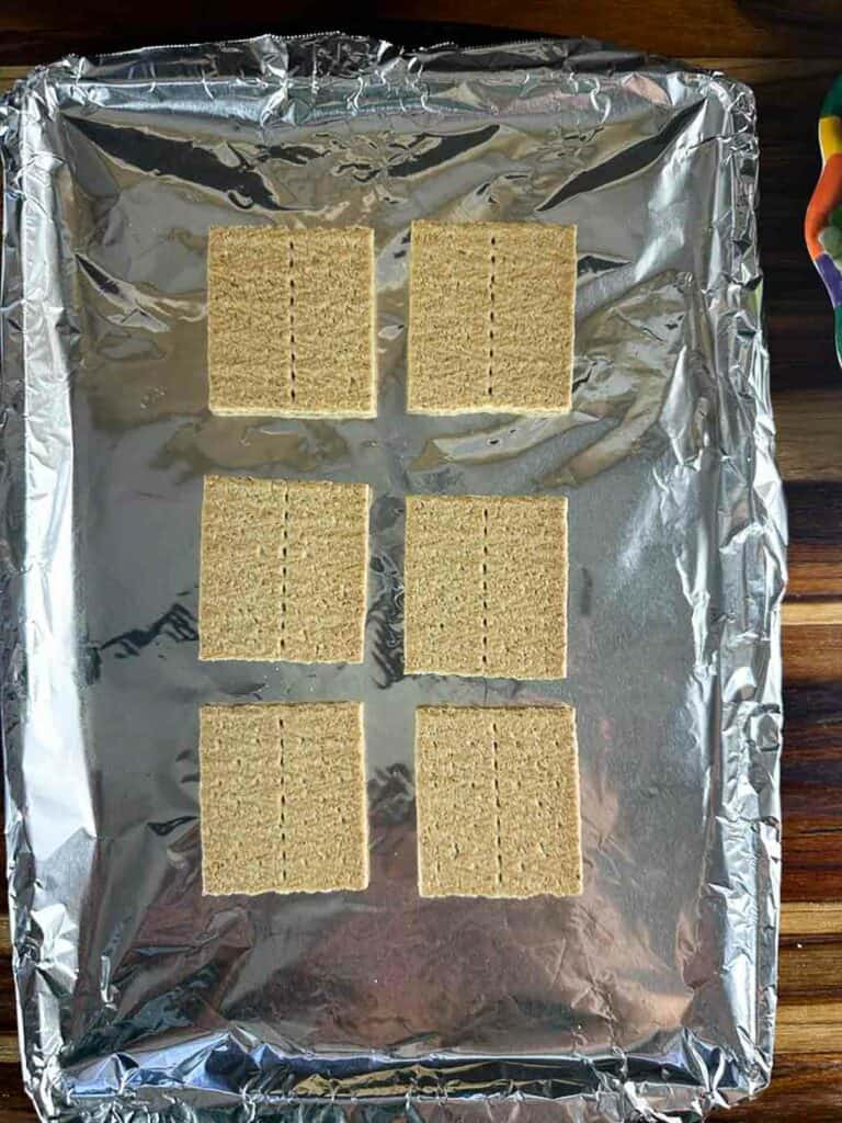 Lay the graham crackers out on a sheet pan lined with foil.