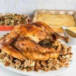 Roasted turkey in a convection oven with gravy, stuffing, and corn bread.