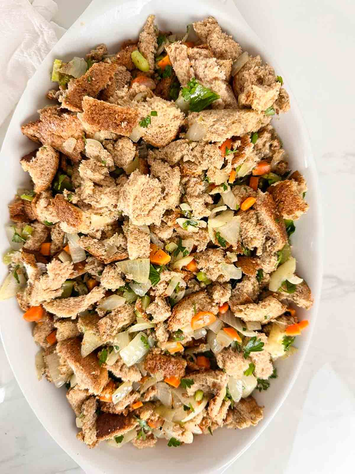 Classic homemade stuffing in a casserole dish before baking.