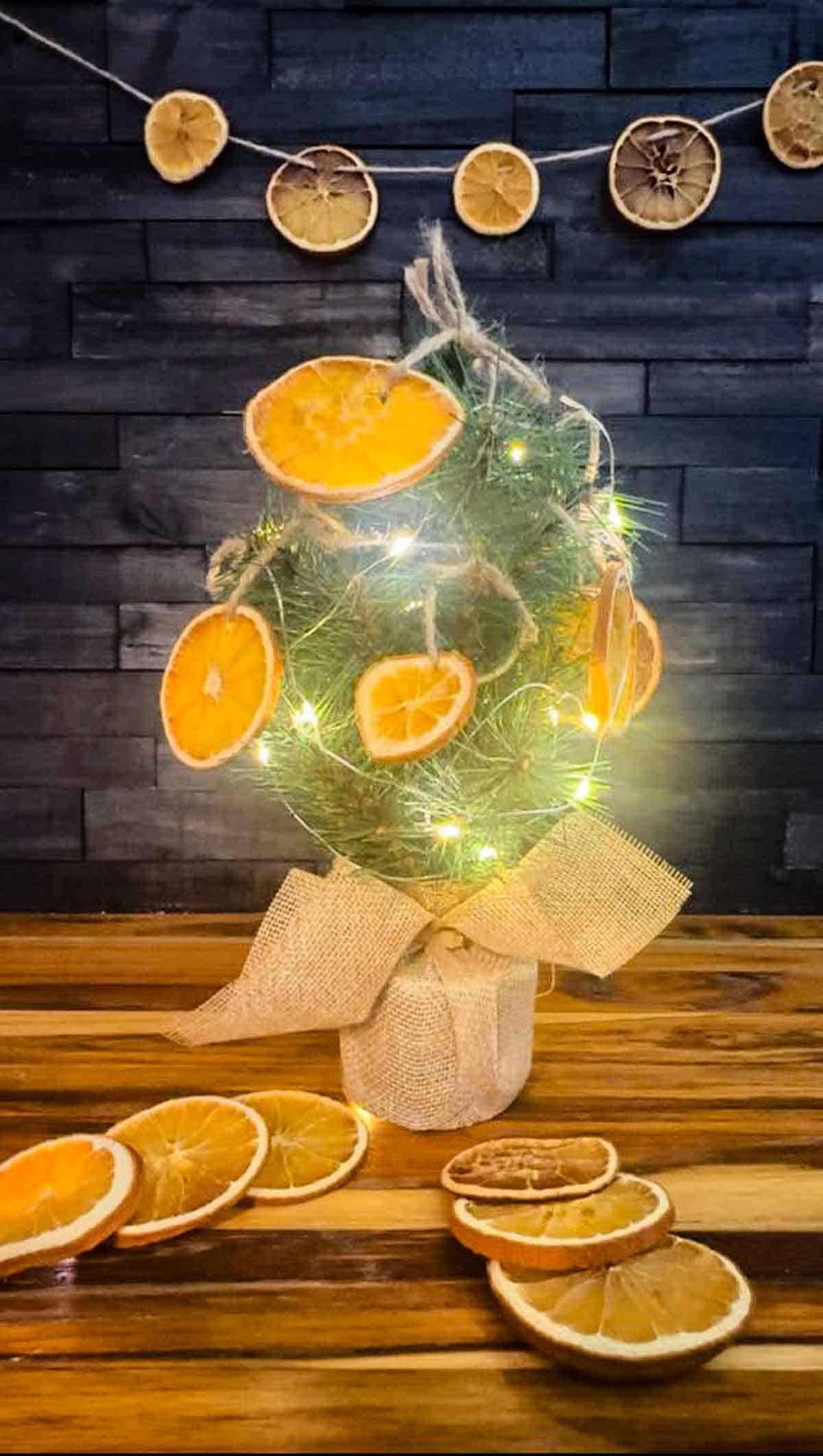 Oven Dried Orange Slice Ornaments on a table top Christmas tree