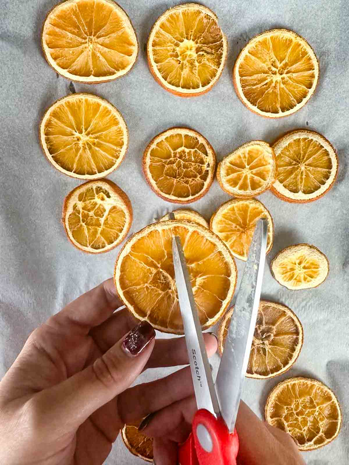 Poke a hole in the dried orange slice to give you a spot to thread twine or ribbon through