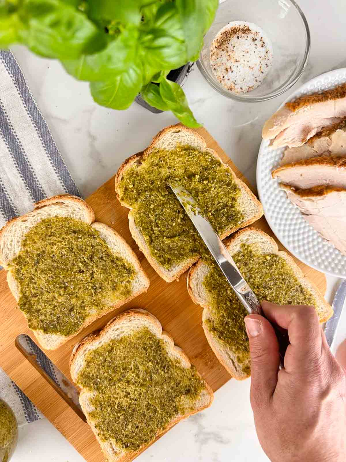 Spread pesto on the side of the bread that isn't buttered.