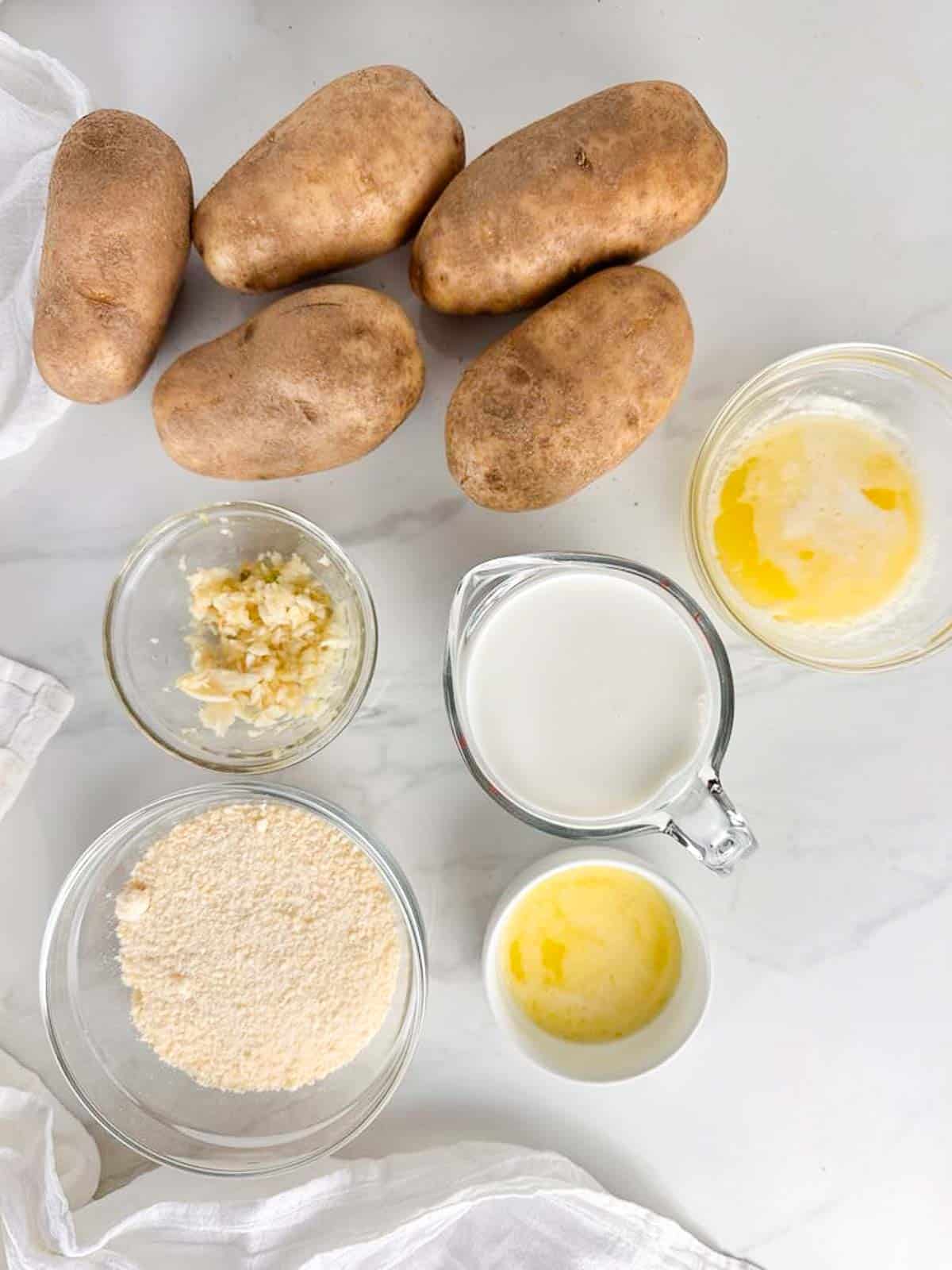 Ingredients for Twice Baked Potato Casserole: Baked Potatoes, Garlic, Butter, Half and Half, and Parmesan Cheese