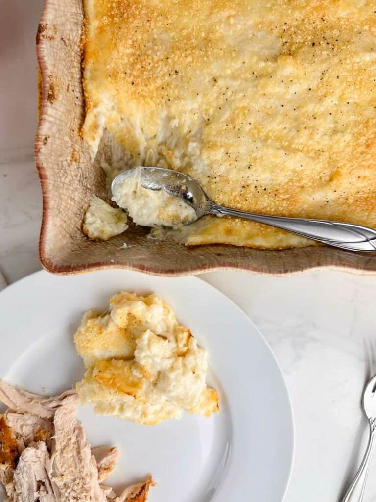 a serving of twice baked potato casserole spooned onto a plate with turkey