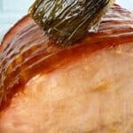 Brown Sugar Ham Glaze (3-ingredient ham glaze) being basted onto a ham