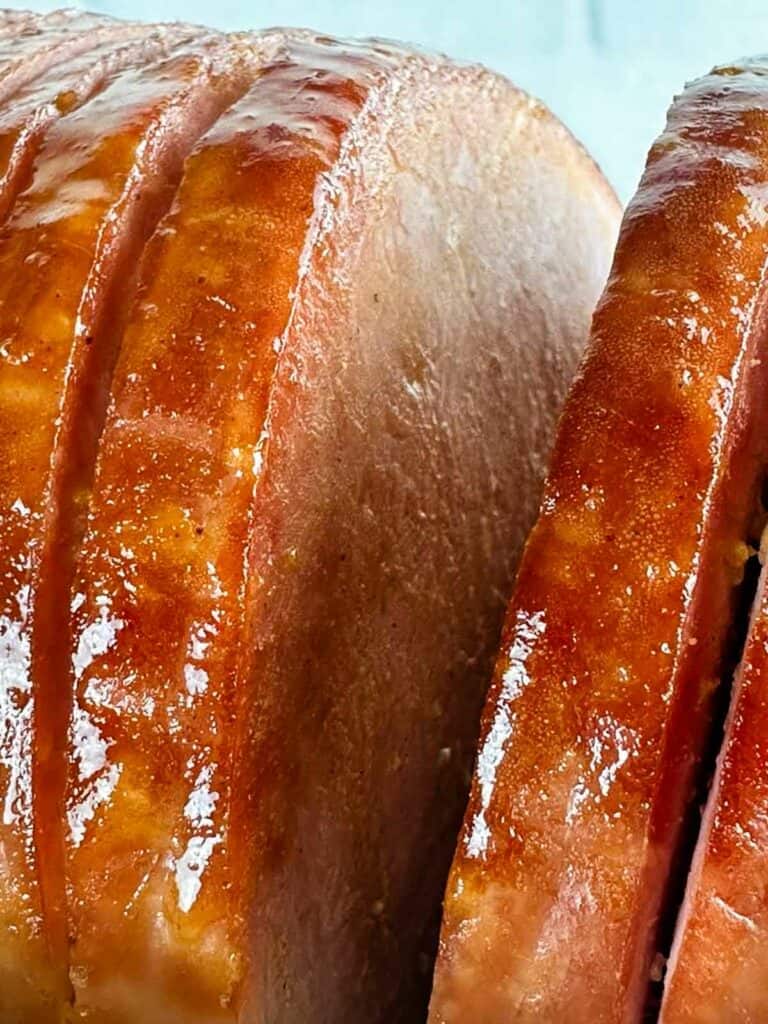 Brown Sugar Ham Glaze (3-ingredient ham glaze) being basted onto a ham