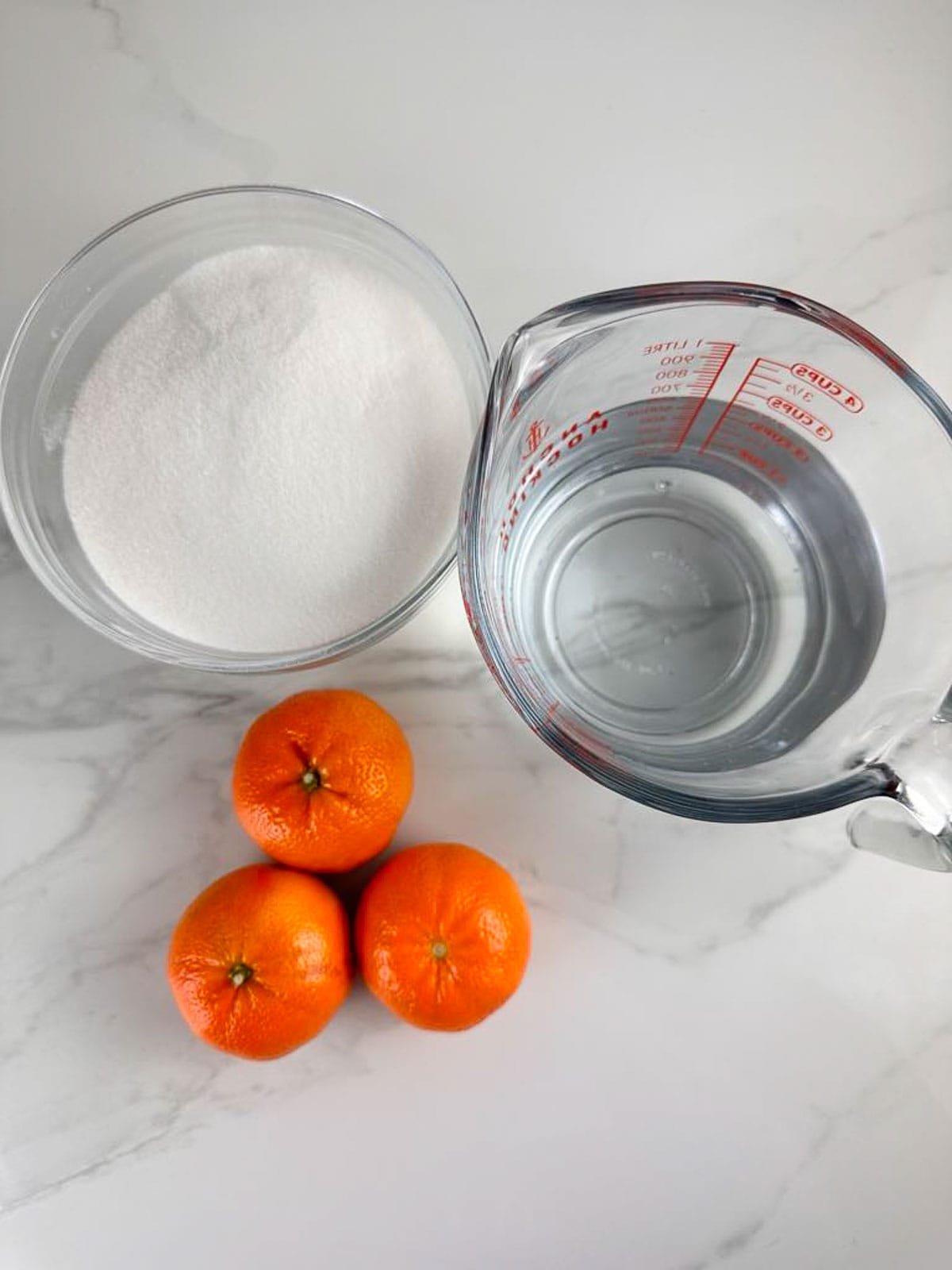 Ingredients for candied orange slices: sugar, water, and oranges.