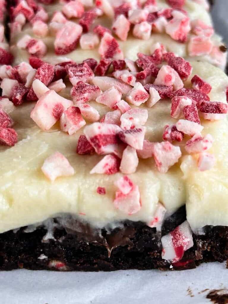 Piece of peppermint brownies with peppermint icing and crushed peppermint candies.